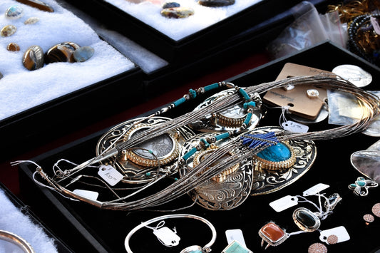 silver-colored jewelries on black case
