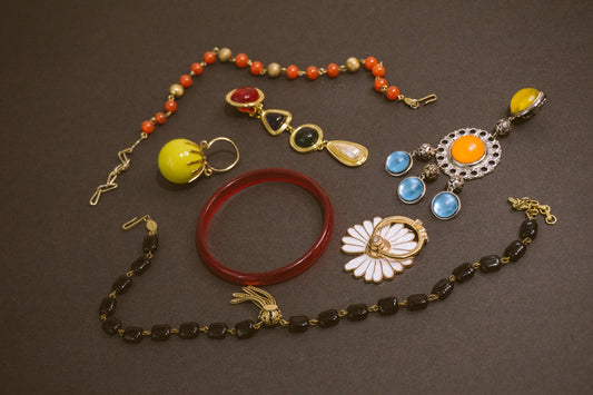 a bunch of jewelry that is laying on a table