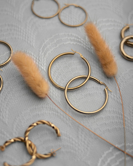 a close up of some gold rings and some feathers