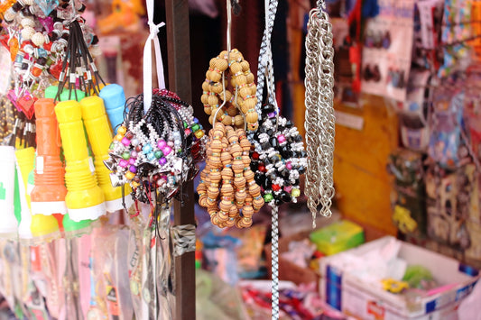 a bunch of necklaces are hanging on a rack