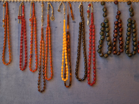 a number of necklaces hanging on a wall