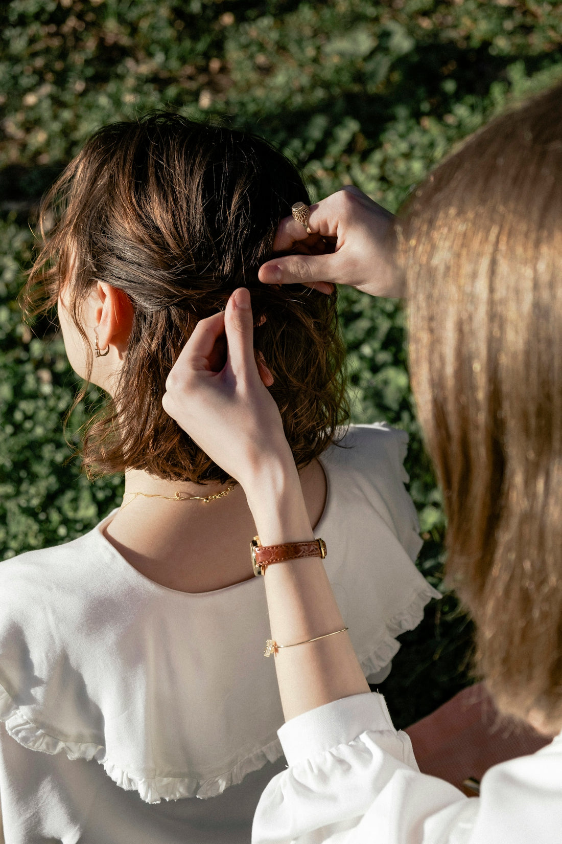 A woman in a white shirt is combing her hair