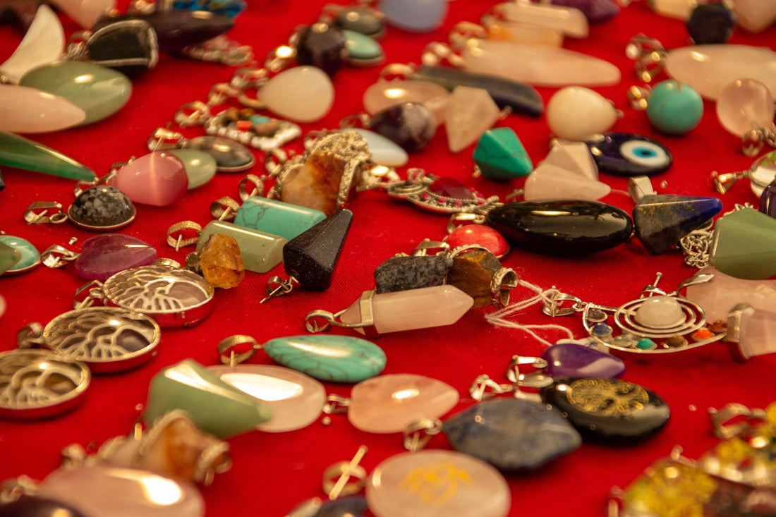 A table topped with lots of different types of necklaces