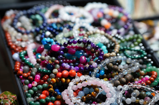 A table topped with lots of beads and bracelets