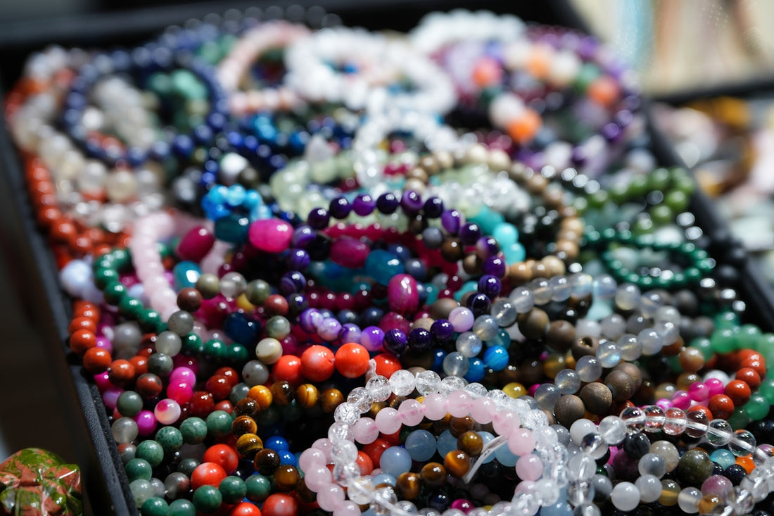 A table topped with lots of beads and bracelets