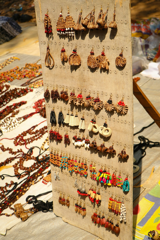 Earrings displayed at an outdoor market.
