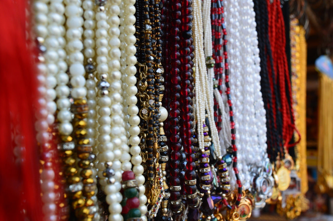 Close up of various beaded necklaces hanging