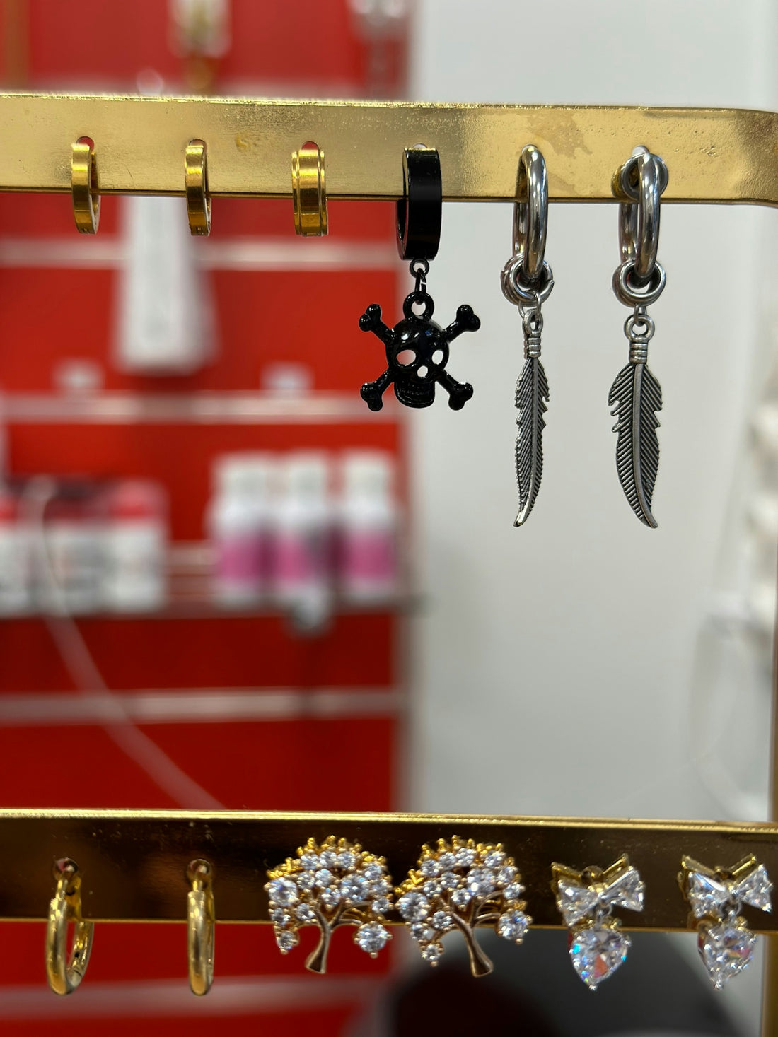 Various earrings displayed on a rack.