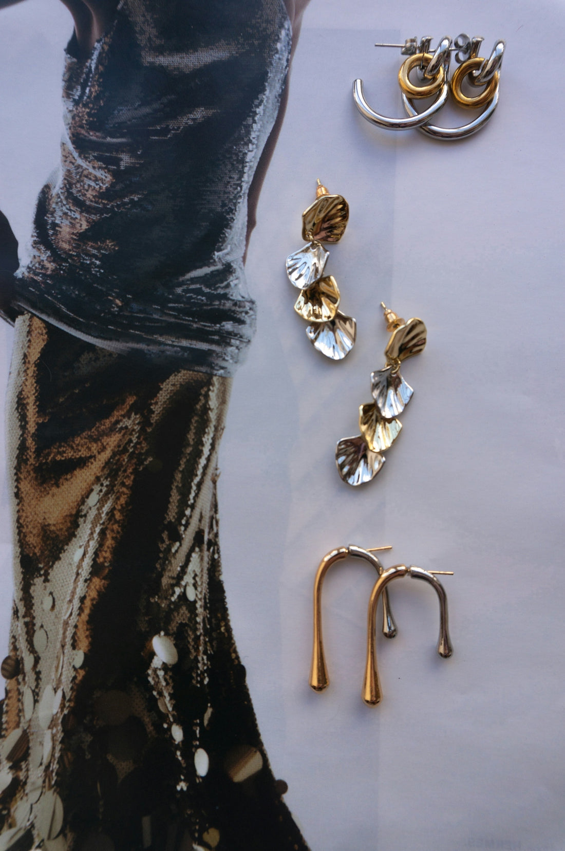 Assorted elegant gold and silver earrings displayed artfully.