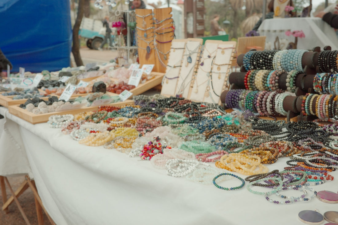 Table full of colorful handmade bracelets and necklaces
