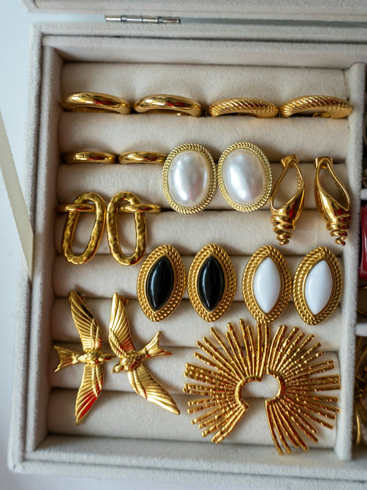 Collection of gold and pearl vintage earrings in jewelry box